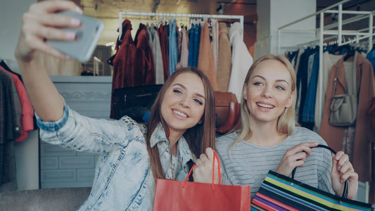 Two women are taking a selfie while shopping.